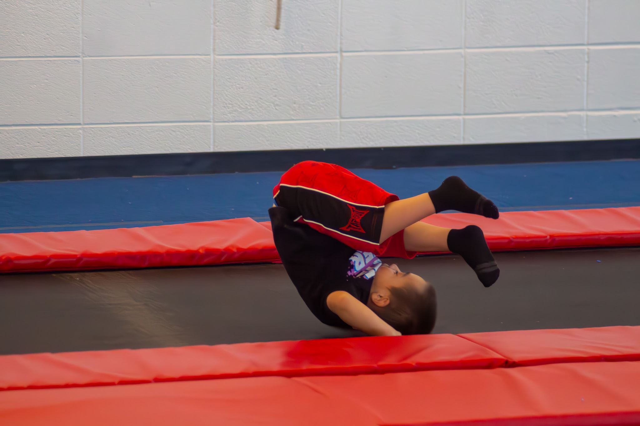 Kid Rolling on Trampoline