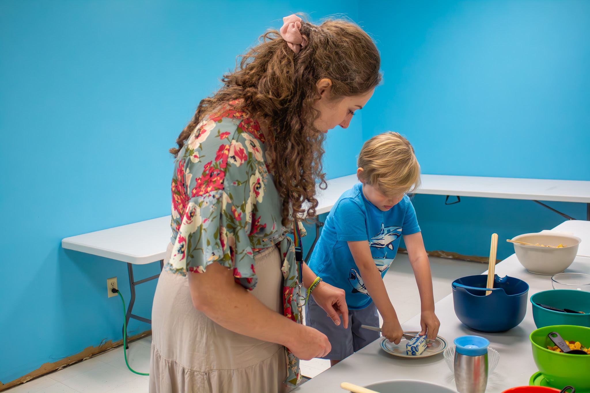 Katie is helping a student cook